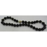 A black onyx necklace with yellow metal spacers on a 14ct yellow gold ball clasp, approx 18" long,