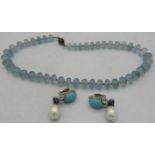 A graduated aquamarine bead necklace with yellow metal clasp. Largest bead approx 12mm x 8mm,