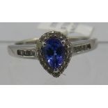 Fine faceted pear cut Tanzanite solitaire of good cut & clarity. Round cut halo set diamonds &