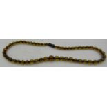 A faceted amber bead necklace, with screw clasp, contemporary but with a hint of Art Deco revival,