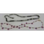 A pink sapphire briolette & white quartz necklace interspersed with small yellow metal beads and