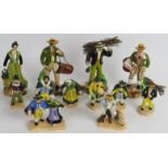 A collection of small hand painted continental pottery figures portraying country peasants. Tallest: