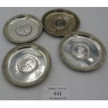 A set of 4 small circular silver dishes inset with one Rupee coins. 1907, 1917 and 1919. Edward