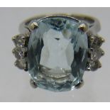 A large cushion cut aquamarine and diamond ring, aquamarine 15mm x 12mm, diamond shoulders