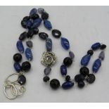 A blue sandstone & chalcedony necklace with four white metal links to the side and a 925 stamped