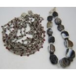 An amethyst & agate eight strand necklace on a large silver clasp and a large stone sardonyx
