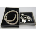 A white metal link bracelet marked 925 with eight heart shaped charms & a white metal heavy coil