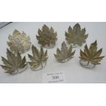 Two types of white metal leaf design menu holders. 7 in total. 53 grams. Condition report: One