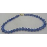 A blue graduated chalcedony necklace interspersed with small yellow metal beads, a 14ct yellow