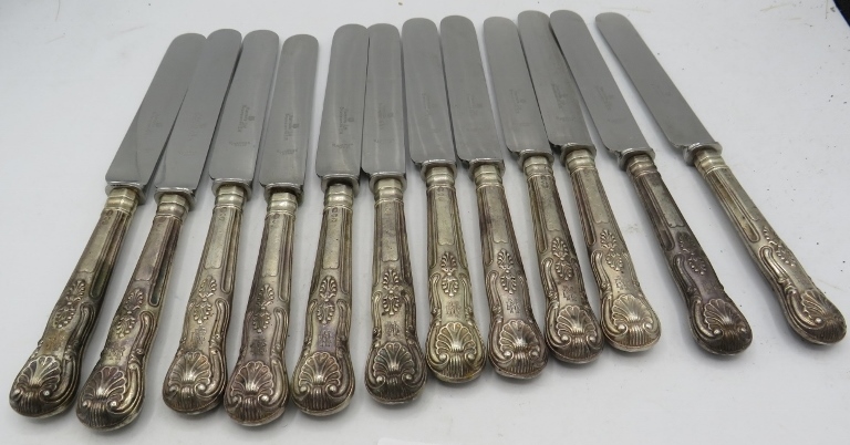 A set of 12 silver handled Queens pattern dinner knives, London 1890. Harrods Ltd. Brompton Road.