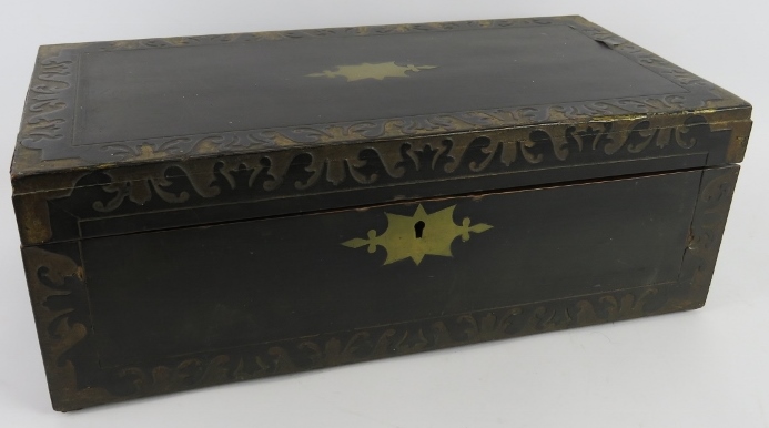 An early 19th century ebonised writing slope with brass and gilt decoration. Internally fitted