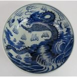 A finely decorated Chinese porcelain bowl with blue and white dragon and pearl decoration.