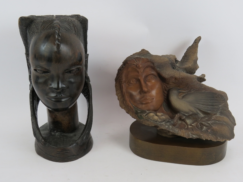 A large carved hardwood African bust of a female and a composite fantasy sculpture of a female and