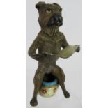 A Vienna Bergmann style cold painted bronze figure of a dog sitting on a chamber pot. Mark to