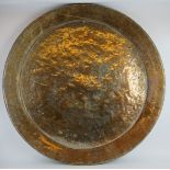 A very large antique Middle Eastern copper charger. 108 cm diameter, with remnants of silver over