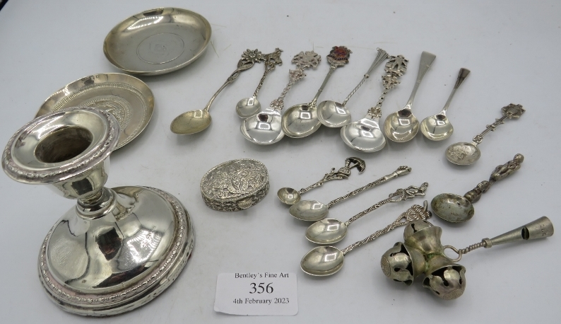 A silver candlestick (hallmarks worn). A Chinese dish with inset coin, one other white metal dish, a