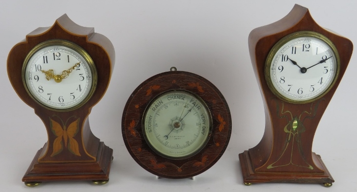 Two inlaid Edwardian balloon shaped mantel clocks, one with butterfly motif, and a similar aneroid