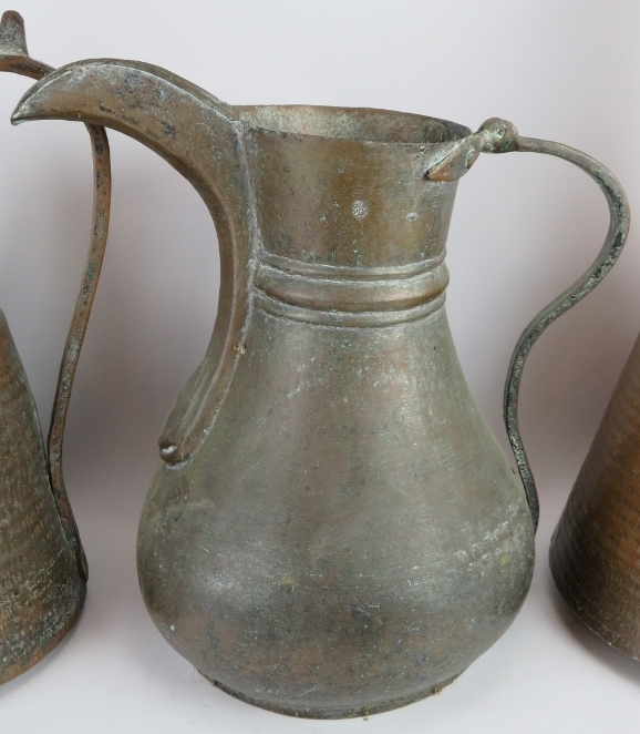 Two large beaten copper Middle Eastern water ewers and a large dallah coffee pot with detachable li - Image 3 of 5