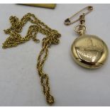 An Elgin pocket watch on a 9ct gold dog clip with a yellow metal chain. Chain 17grams. Boxed.