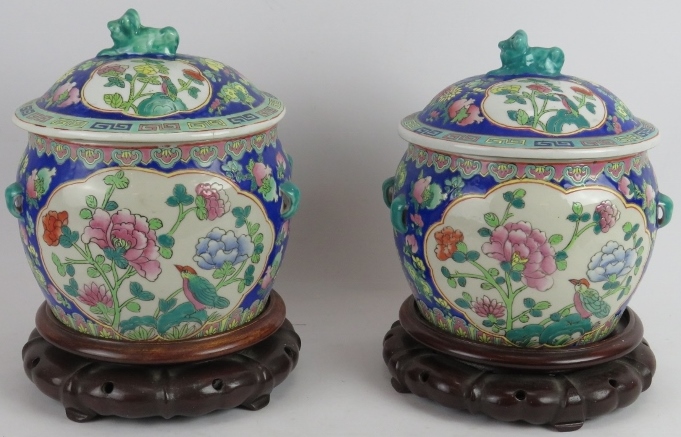 A pair of decorative Chinese porcelain covered fish bowls with interior decoration, each standing on