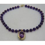 An 18ct yellow gold pendant set with large amethyst, approx 25mm x 18mm and surrounded by 12