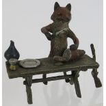 A Vienna Bergmann style cold painted bronze figure of a fox carving meat at a table. Mark to