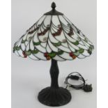 A Tiffany style table lamp by Loxton Lighting with jewelled glass shade of berry and leaf pattern,