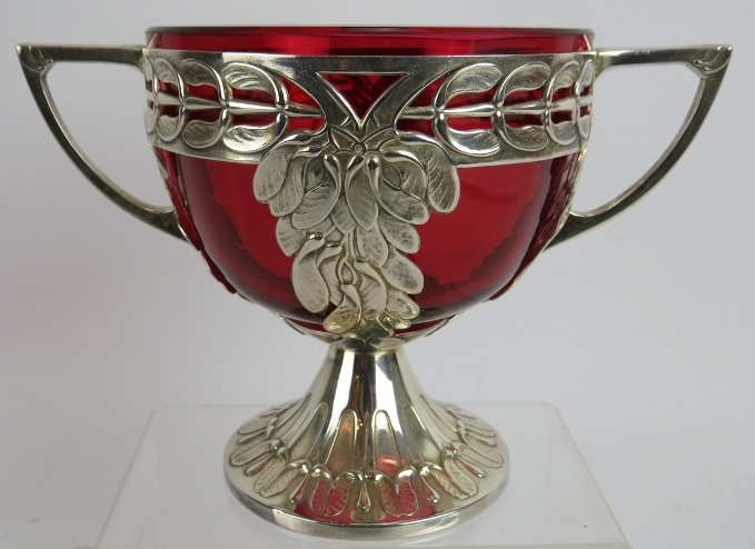 An early 20th century WMF silver plated two handled bowl with Cranberry glass liner and mistletoe