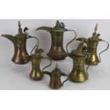 Six antique copper and brass Middle Eastern dallah coffee pots of varying size. Tallest: 30cm. (