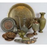 A mixed lot of Indo-Persian brass and copper wares including a large charger, vases, plates,