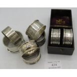 A pair of silver engraved napkin rings. Birmingham 1900. Boxed. A collection of 5 silver napkin