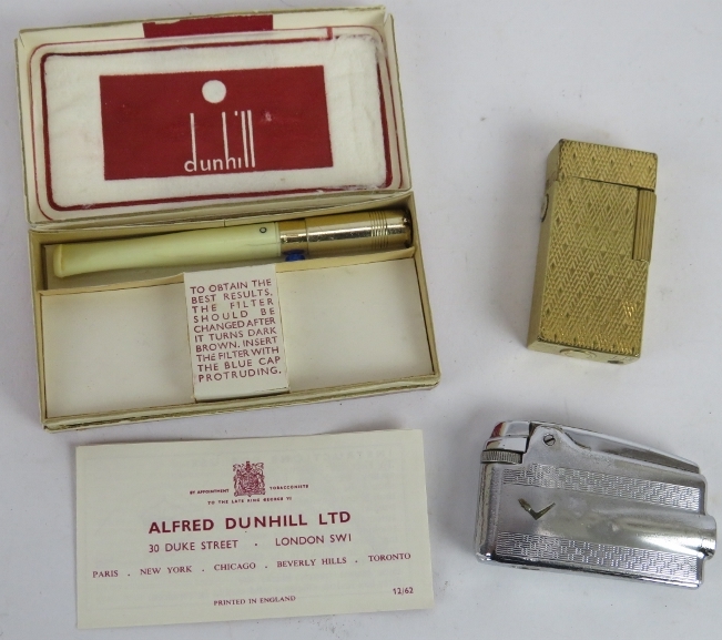 A gold plated Dunhill 70 cigarette lighter, a Dunhill white spot cigarette holder and a Ronson