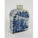 A small 18th century Chinese porcelain tea caddy with blue and white decoration, arched shoulders