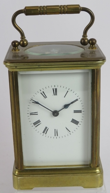 A brass cased 8 day carriage clock with white enamel dial. Overall height: 16cm. Key present.