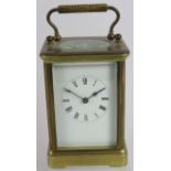 A brass cased 8 day carriage clock with white enamel dial. Overall height: 16cm. Key present.