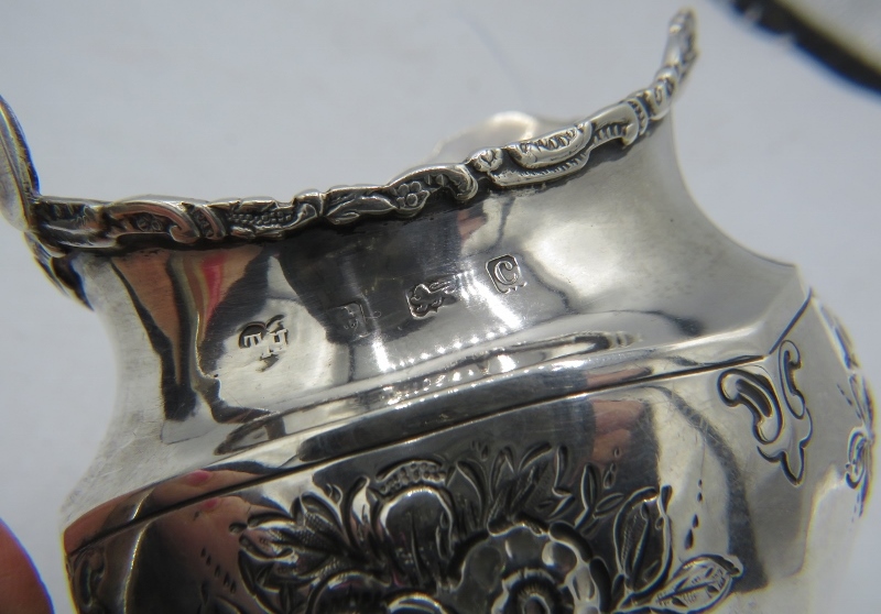 A pretty silver cream jug on ball feet. Embossed with flowers. Birmingham 1902. Thomas Hays. 3 - Image 2 of 2