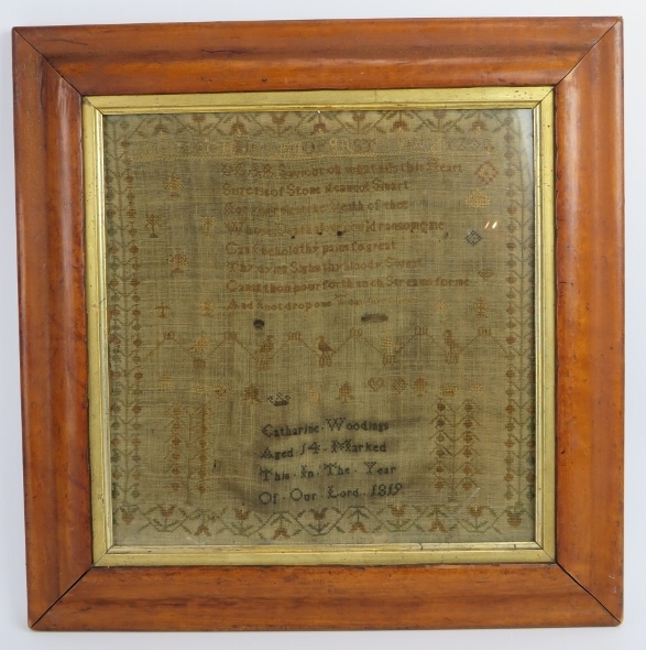 A Georgian needlework sampler by Catherine Woodings, aged 14, 1819. Mounted in a period maple frame