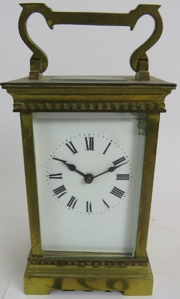 An early 20th century brass cased carriage clock, 12cm high. Condition report: White enamel dial