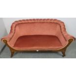 An Edwardian two-seater scroll-back sofa, the patterned pink upholstery with braided rope trim,