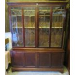 A George III Cuban mahogany tall glazed bookcase, the astral glazed doors opening onto three