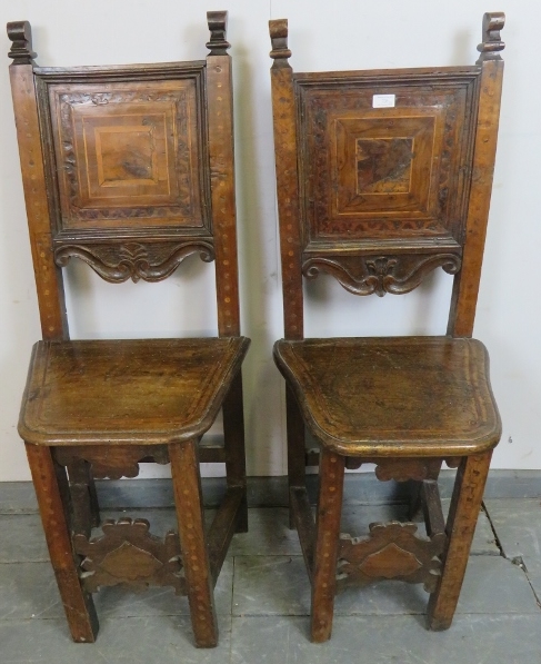 A pair of 17th century and later cherrywood Tyrolean his and hers inlaid hall chairs, the back