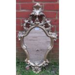 A vintage wall mirror in the 18th century Italian taste in ornate gilt gesso frame
