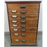 An early 20th century flight of eight graduated drawers with steel scalloped handles and scalloped