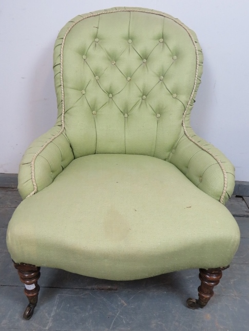 A Victorian bedroom chair, reupholstered in green buttoned material, on tapering walnut supports