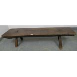 A substantial antique hog bench, believed to be 17th/18th century, on canted supports. H30 W140 D39