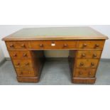A Victorian walnut pedestal desk, with inset green leather gilt tooled writing surface, housing an