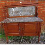 A turn of the century mahogany washstand with marble top and splashback and cupboard under, on