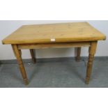 An antique pine kitchen table with single drawer to one side, on tapering turned supports. H73