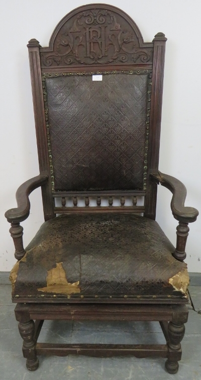 An unusual 19th century mahogany height adjustable throne chair, the cornice with relief carved