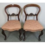 A pair of Victorian mahogany side chairs with carved backs, nicely reupholstered in pink damask